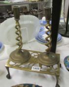 A pair of brass candlesticks and a trivet