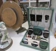 A cased vanity set, a straw boater and a brass frame