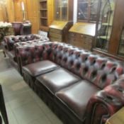 A leather Chesterfield, matching chair and wing armchair