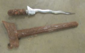 An ornamental dagger in carved wood sheath