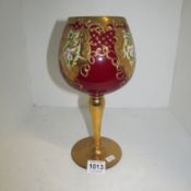 A large ruby glass goblet decorated with gold