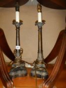 A pair of bronze effect metal table lamps