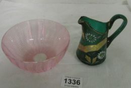 A cranberry glass bowl and a hand painted green glass jug