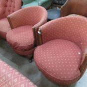 A pair of pink tub chairs