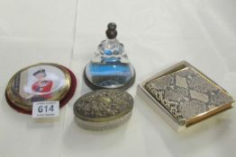 A snakeskin purse, compact, trinket pot and paperweight