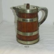 A Victorian wood water jug with nickle rings