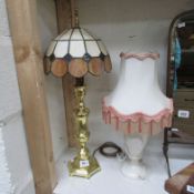 A table lamp with Tiffany style shade and one other