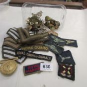 A quantity of military badges and buttons