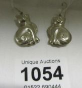 A pair of silver cat earrings