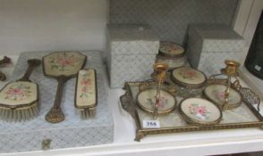 A vintage boxed trinket and vanity set with floral insets