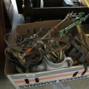 A box of miscellaneous including table lamp, carpet beaters.