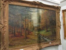 A gilt framed oil on canvas forest scene