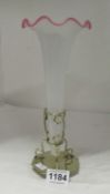 A single trumpet opaque glass spill vase on plated stand