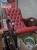 A red leather deep buttoned rocking chair