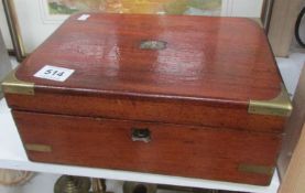 A mahogany box with brass corners