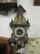 A brass and wood wall clock