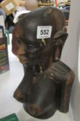 A carved African figure bust