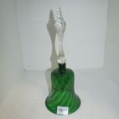 A green glass bell with clear handle
