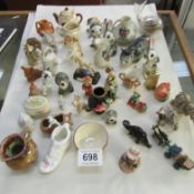 A quantity of small china animals, cats etc