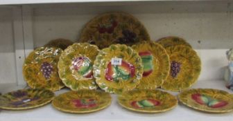 A quantity of French fruit decorated plates