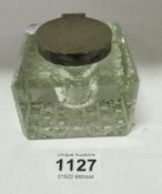 A silver topped glass inkwell