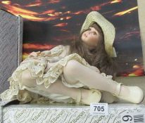 A boxed Alberon seated porcelain doll