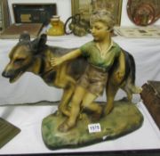 A Deco plaster figure of boy with dog