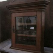 A small mahogany corner cupboard