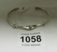 A silver twist open end bracelet