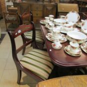 A mahogany dining table and set of 4 brass inlaid chairs