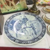 A large blue and white charger depicting lady and gentleman