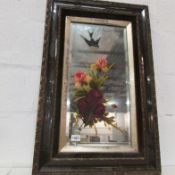 A hand painted framed mirror