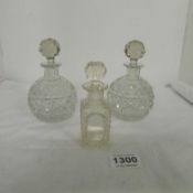 A pair of cut glass scent bottles and one other