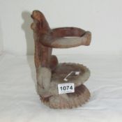 A carved wood crocodile bottle stand
