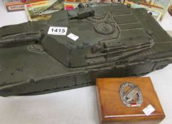 A model of an M1 tank originally used for instruction purposes and a small box with German badge