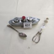 A cruet in the shape of a ship, a pickle claw and a spoon