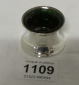 A silver salt with green glass liner