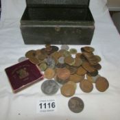 A metal box of coins including 3 crowns