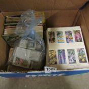 A box of cigarette and tea cards, loose and in albums