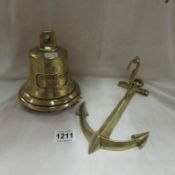 A brass bell marked 'MS Brennen 1911' with anchor bracket