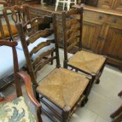 A pair of oak ladderback chairs