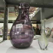 A large purple glass vase and one other