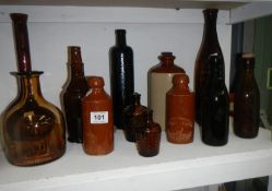 A quantity of brown glass and stoneware bottles