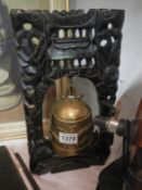 A brass prayer bell on ebony stand