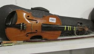 A three quarter violin and bow with case