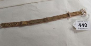 A yellow metal bracelet