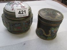 A cloissonne lidded pot and a brass pot with porcelain lid