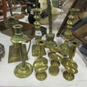 A mixed lot of brass candlesticks, door stop etc