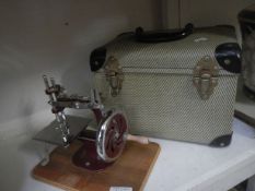A miniature sewing machine in case