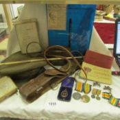 A cap, WW1 medals with miniatures, personal items and ephemera from 2nd Lt. G E Moss